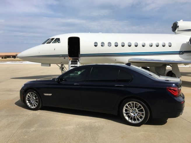 car next to luxury jet